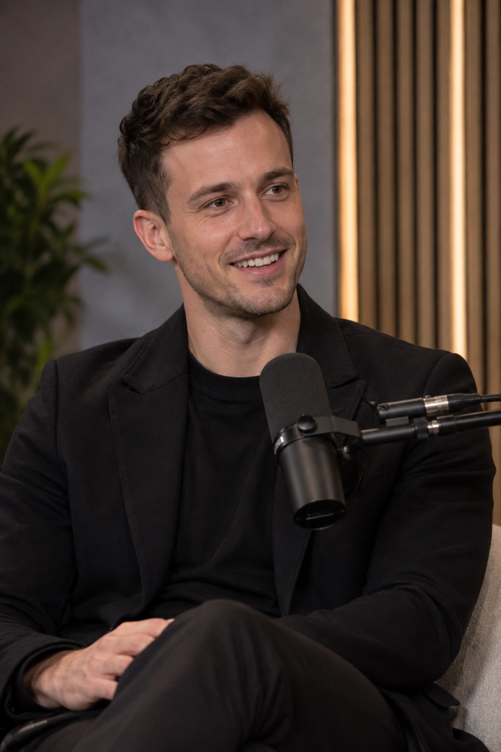 Liam in a blazer during a podcast interview